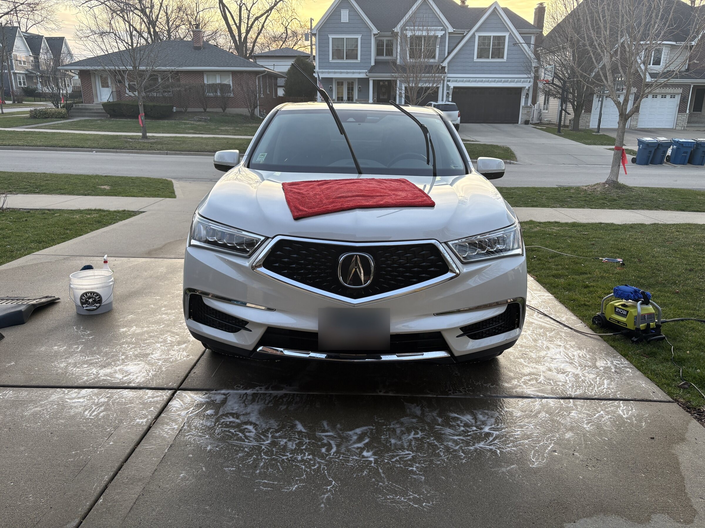 Freshly detailed white Acura on a driveway